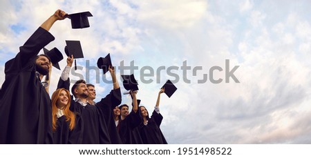 Millennial students celebrating graduation ceremony and throwing their caps up outdoors, copy space text. Young people on commencement day Royalty-Free Stock Photo #1951498522