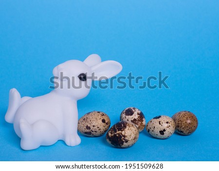 easter background. figurine of an Easter bunny and quail eggs. space for text