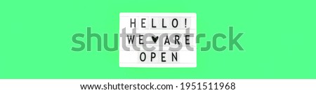 Lightbox with text message Hello we are open sign, banner with notification after quarantine, reopening concept photo