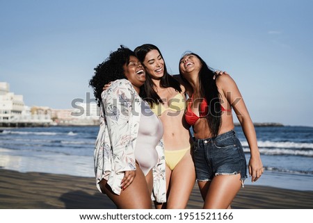 Happy multiracial women with different bodies and skins having fun in summer day on the beach - Focus on faces