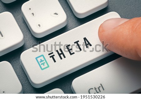 Index finger pressing computer key with theta token logo.  Cryptocurrency mining or trading concept. Royalty-Free Stock Photo #1951530226