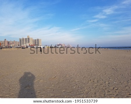 Shadow of a beachgoer taking a picture