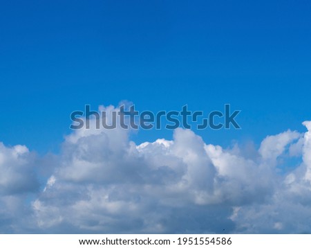 white clouds illuminated by the sun in an azure sky