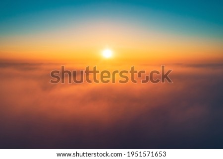 Flying above the clouds at sunrise
