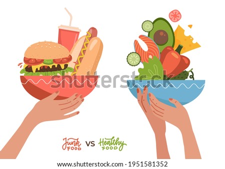 Food choice concept. Two hands with healthy and fresh vegetables, fish, cheees and junk unhealthy fast food. Concept diet - plate with organic meal versus fast food plate with burger, hotdog and soda Royalty-Free Stock Photo #1951581352