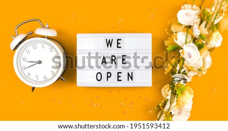 Concept of the end of quarantine, we are open text sign, lightbox background photo