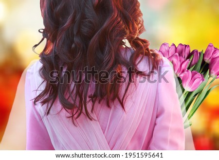 Happy young girl or woman holds fresh flowers. women's day concept.