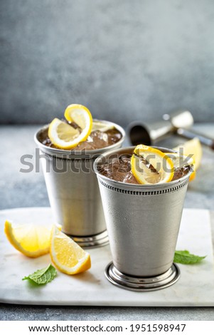 Lemon mint julep cocktail with wiskey in traditional glasses