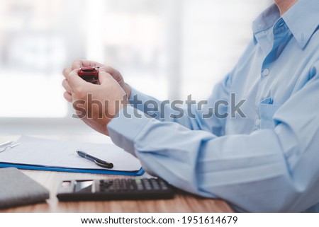 Man holding a accident toy car in a hand and insurance documents,pen,calculator on wood table : Car Damage assessment and insurance concept 