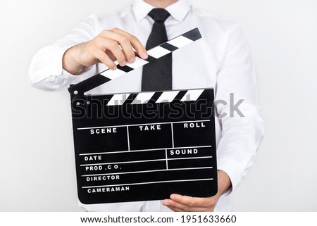 Close up Of A Businessman Holding Clapperboard Over White Background