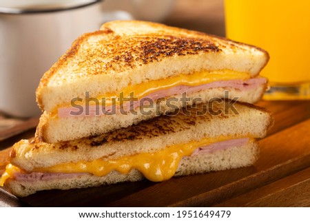 Grilled ham and cheese. Sandwich with cheese and ham on grill. Royalty-Free Stock Photo #1951649479