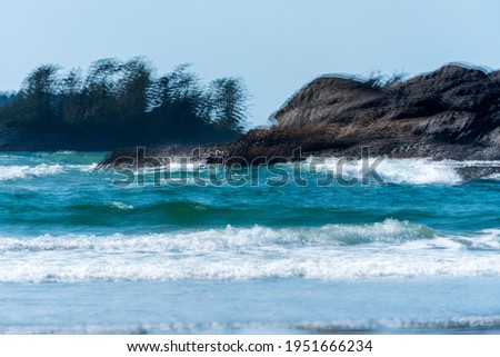 A blurry picture of sea waves crashing on a reef