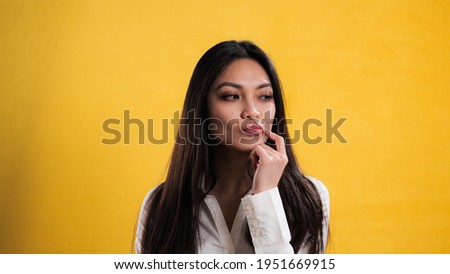 Young thoughtful woman has an idea - studio photography
