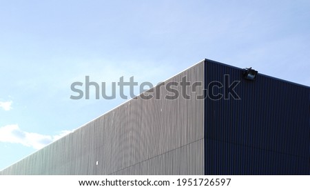 roof and angle of facade of industrial warehouse Royalty-Free Stock Photo #1951726597