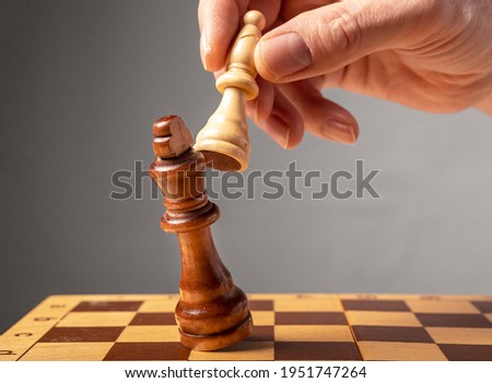 Business strategy concept. Knight making final last step to make checkmate in chess, falling king. Royalty-Free Stock Photo #1951747264
