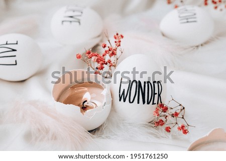 Easter DIY. Do it yourself. Trendy Easter eggs Composition. Easter message, Words drawn with pen. High Angle View Of Shells On Table. Wonder. Candle in egg shell. Candle light Pastel colors.