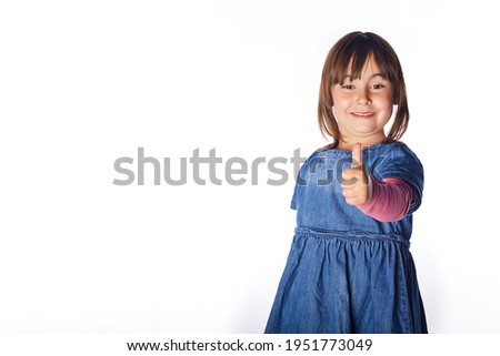 Portrait of happy girl showing thumbs up gesture, isolated over white background with a big copy space