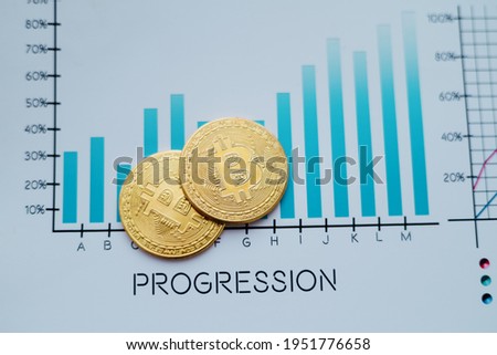 image of bitcoins and a financial chart on an office desk.