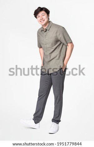 Man in gray shirt and pants casual wear fashion full body Royalty-Free Stock Photo #1951779844