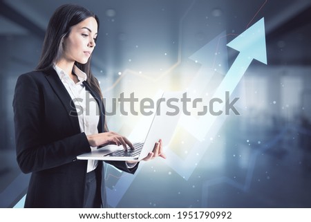 Successful investing concept with trader woman working on laptop and digital growing arrows on background