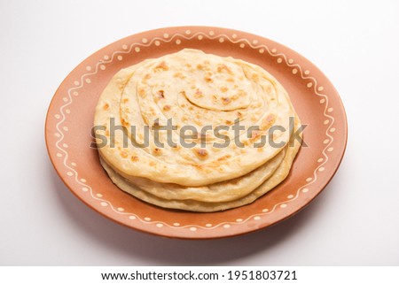 Laccha Paratha is a layered Puffed Flatbread with lots of ghee or oil Royalty-Free Stock Photo #1951803721