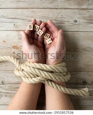 male hands are tied and hold letters with word addiction, concept addiction, photo taken from above