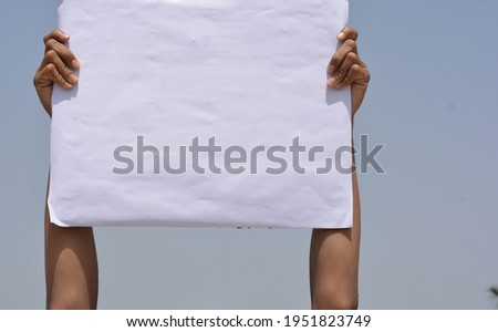 White banner in hand in sky background