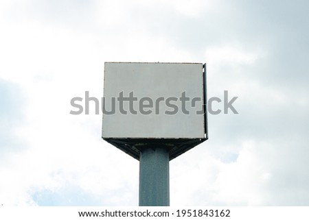 Blank triangular billboard on the cloudy sky background. Blank billboard. Billboard mockup