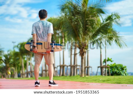Hello Summer Surfers people Asian having fun with surfboards or surf skate around city streets background on a summer day. Free relax lifestyle and millennial trend concept