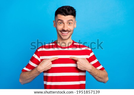 Photo of amazed happy handsome man ask point fingers me winner isolated on pastel blue color background