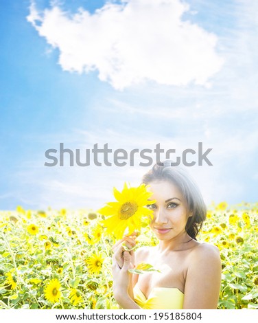 Close-up portrait of young adult beautiful joyful latin hispanic woman with sunflower girl with long brunette hair inhales aroma of wild flowers  copy Space for inscription