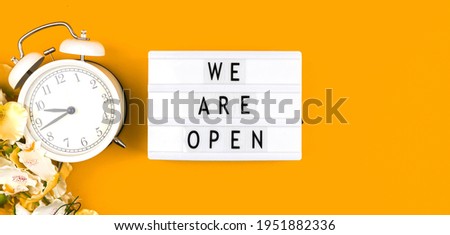 We are open sign banner background, lightbox with text message on a yellow background photo