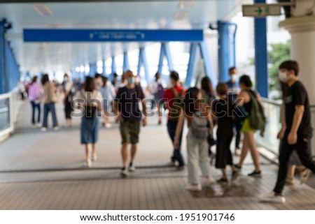 blurred Crowd of busy people with face mask walking in Central, Hong Kong during Covid-19 Royalty-Free Stock Photo #1951901746