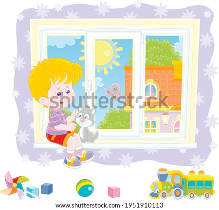 Little boy playing with his cute small kitten on a windowsill in a nursery room with starry wallpaper and funny colorful toys on a sunny summer day, vector cartoon illustration