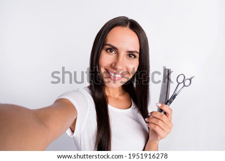 Photo of nice optimistic brunette lady with brush scissors do selfie wear white t-shirt isolated on grey color background