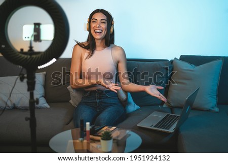 Female influencer vlogging online  with smartphone cam and laptop from home - Youth people with social media and smart working concept  Royalty-Free Stock Photo #1951924132