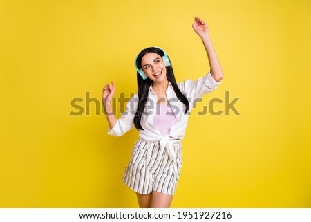 Photo of dreamy pretty happy lady look empty space dance wear headset isolated on yellow color background