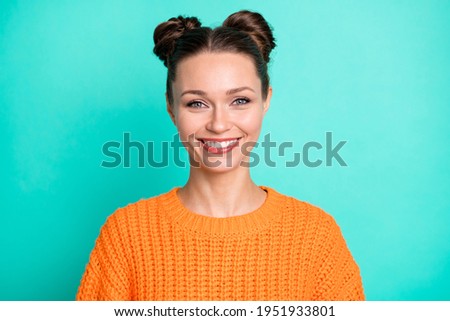 Photo portrait of pretty girl in orange sweater smiling isolated on bright teal color background