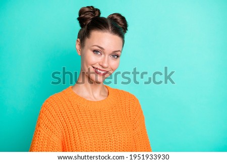 Photo portrait of pretty girl with girlish hairdo smiling wearing orange knitted sweater isolated vivid teal color background