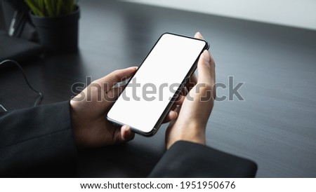 Mock up image of businesswoman holding smart phone with white screen. Blank screen for advertise text.