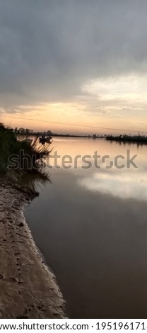 This is the picture of bank of the Jhelum river along with the beautiful sky and trees at the time of sun set