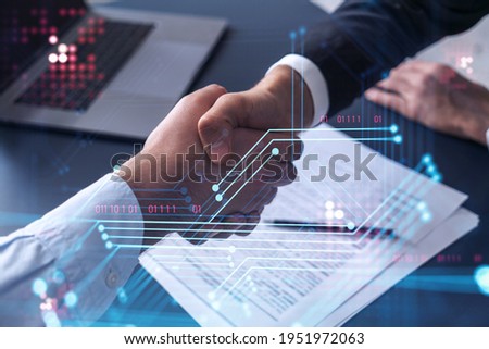 Handshake of two businessmen who enters into the contract to develop a new software to improve business service at a company. Technological icons over the table with the document. Royalty-Free Stock Photo #1951972063