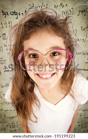 Closeup portrait, headshot happy, smiling, excited, funny looking, little girl with big glasses, messy hair, isolated background with science, math formulas. Positive human emotion, facial expression