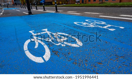 Bicycle lane sign and blue painted tarmac
