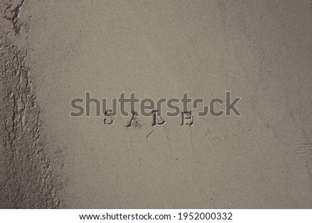 Text "SALE" written on a cement wall.
