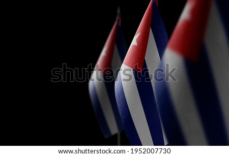 Small national flags of the Cuba on a black background