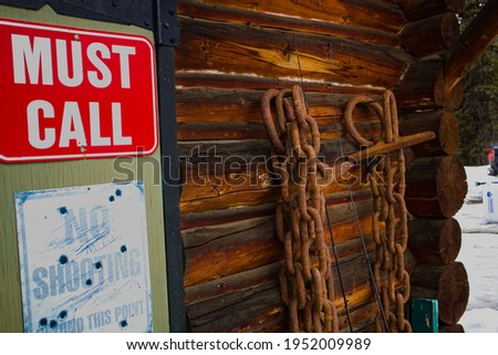 Chains hanging up on a log workshop
