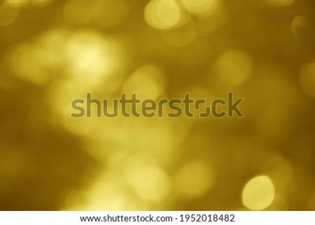 Abstract blurry bokeh with golden brown color used for background.