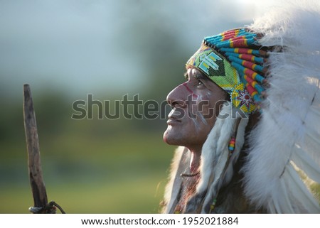 Portrait native American red Indian looking up with nature background