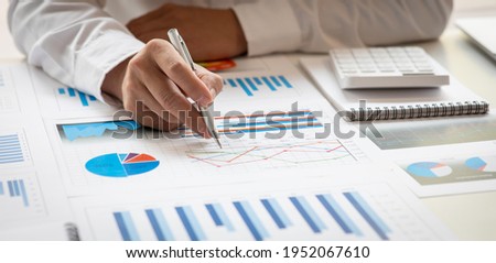 Businessman hands hold documents with financial statistic stock photo,discussion and analysis data the charts and graphs. Finance concept